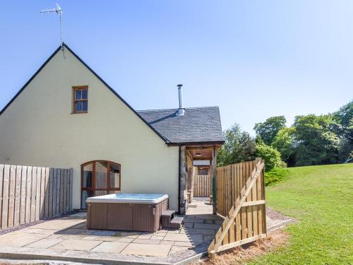 a house with a hot tub in a yard at Beech Cottage - Ukc6252 in Linlithgow