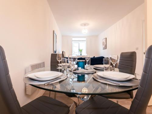 a dining room with a glass table and chairs at Flat 1-Uk41147 in Southampton