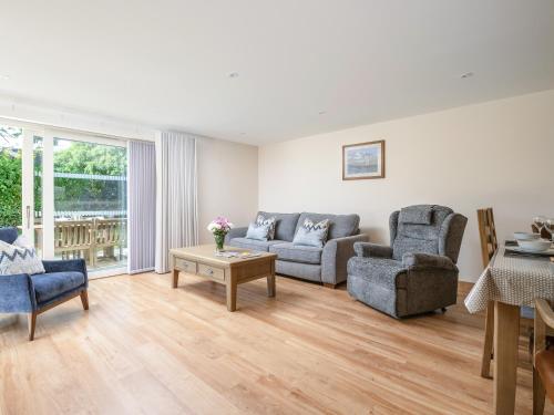a living room with a couch and two chairs and a table at Emsdorf Lodge - Ukc5800 in Lundin Links