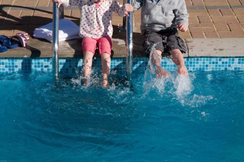 a man and a child playing in a swimming pool at Fistral Cottage - Cwc46839 in Perranporth