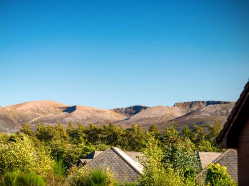 a view of the mountains from a house at Munro View - Ukc5040 in Aviemore