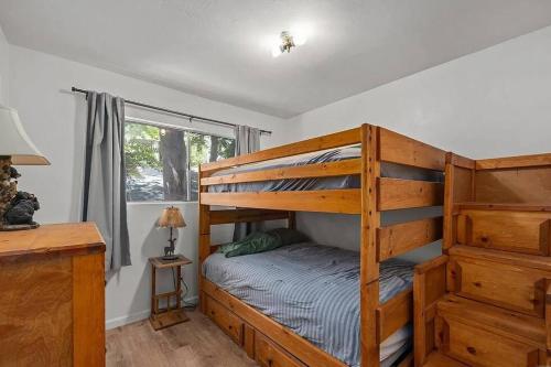 a bedroom with two bunk beds and a window at Riverkern Retreat House in Kernville