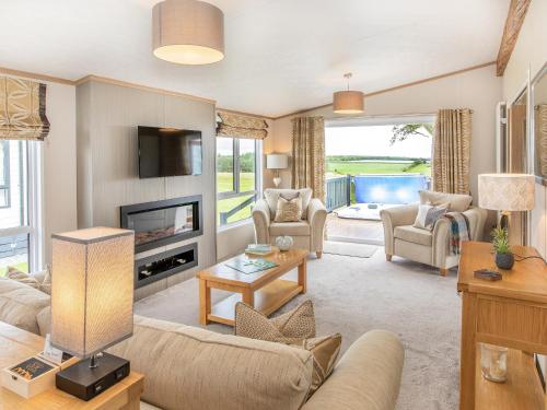 a living room with a couch and a tv at Rivendale in St. Andrews