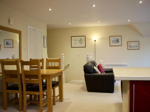 a living room with a couch and a table at Pine View in Invergarry