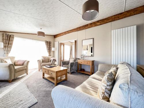 a living room with a couch and a table at Rivendale 52 in St. Andrews