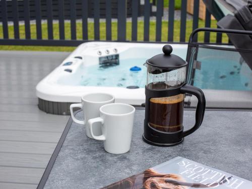 a coffee maker sitting on a table next to a hot tub at Rivendale 8 in St. Andrews