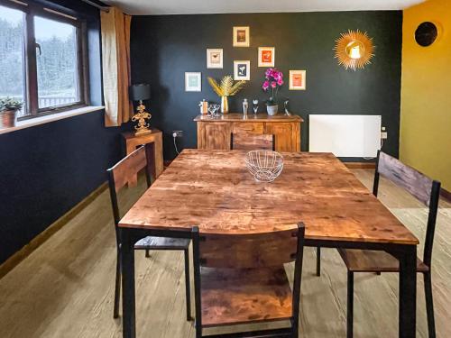 a dining room with a wooden table and chairs at Holly Cottage in Uckfield