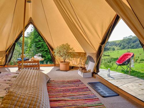 a tent with a bed and a view of a field at Poppy- Ukc4939 in West Anstey