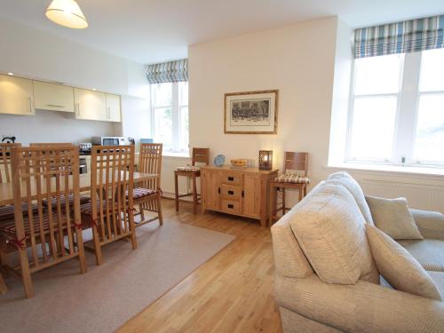 a living room with a couch and a dining room at Monastery 13 - Abbots Rest - Ukc4886 in Fort Augustus