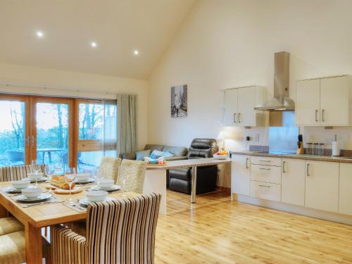 a kitchen and living room with a table and chairs at Homelands-Cardy in Lundin Links
