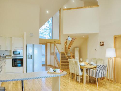 a kitchen and dining room with a table and chairs at Homelands-Cardy in Lundin Links