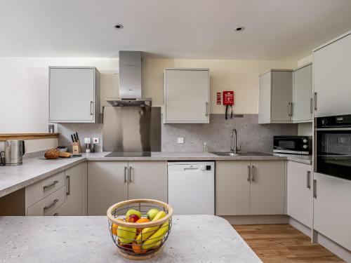 a kitchen with a bowl of fruit on a counter at Durham Lodge - Ukc5799 in Lundin Links