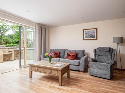 a living room with a couch and two chairs and a coffee table at Durham Lodge - Ukc5799 in Lundin Links