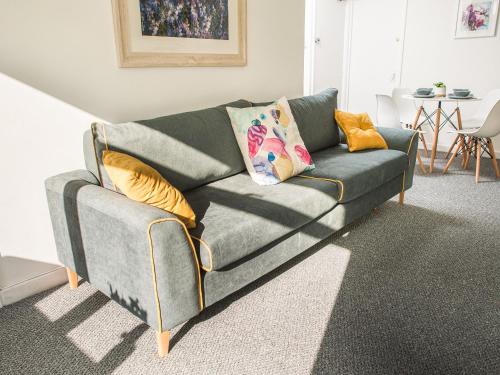 a gray couch with pillows on it in a living room at Newport House Lower in Newport