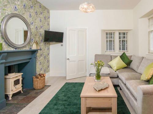 a living room with a couch and a fireplace at Firlands Lodge - Ukc6205 in Nairn