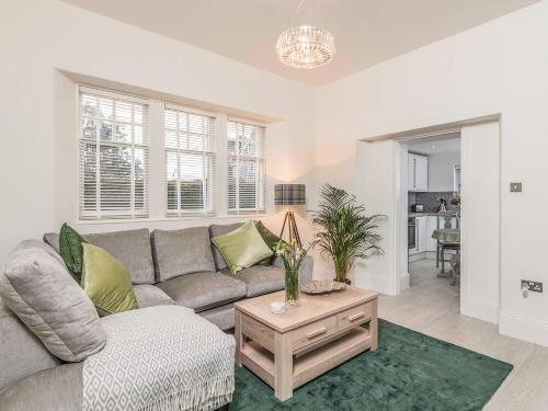 a living room with a couch and a table at Firlands Lodge - Ukc6205 in Nairn