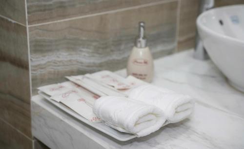 a bathroom with towels on a counter next to a sink at Prime Hotel in Thái Nguyên