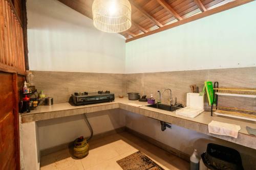 a kitchen with a sink and a counter top at Damar Sanjaya Uttama in Amed