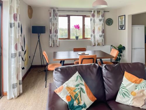a living room with a couch and a table at Cherry Pip in Uckfield