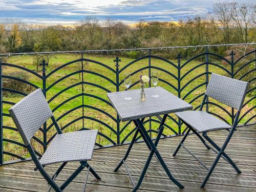 a table and two chairs on a wooden deck at Castle Lodge - Uk50987 in Sheriff Hutton