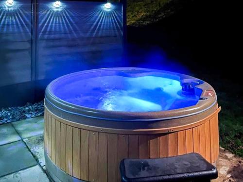 a large hot tub in a backyard at night at Aspen Lodge - Uk51190 in Morpeth