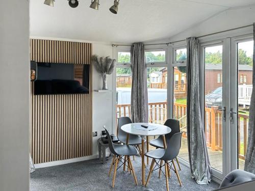 a living room with a table and chairs at Aspen Lodge - Uk51190 in Morpeth
