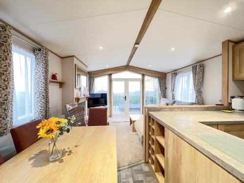 a kitchen with a vase of flowers on a counter at Glenmoore 23 in St. Andrews