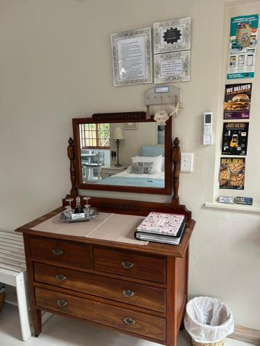 a dresser with a mirror on top of it at Twilight Cottage in Plettenberg Bay