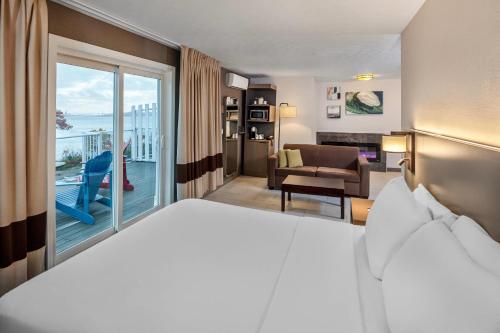 a hotel room with a bed and a balcony at Comfort Inn in Halifax