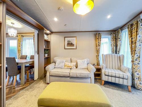 a living room with a couch and chairs and a table at Abington 14 in St. Andrews
