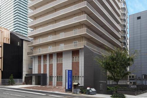 a tall building on the side of a street at Comfort Hotel ERA Kobe Sannomiya in Kobe
