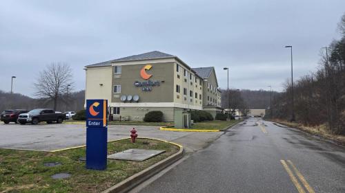 a building on the side of a road with a parking lot at Comfort Inn Barboursville near Huntington Mall area in Barboursville