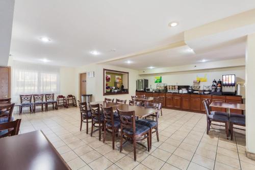a restaurant with a table and chairs and a kitchen at Quality Inn Lincoln Cornhusker in Lincoln