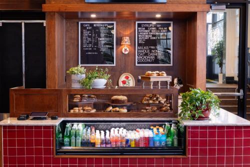 a bakery with a counter with drinks and pastries at Graduate by Hilton Bloomington in Bloomington