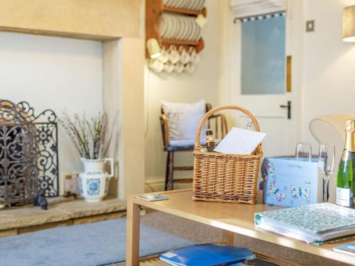 a table with a basket on top of it at Juliet Cottage in Alnwick