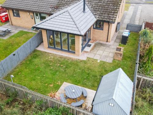 an aerial view of a yard with a house at Dalmore-Ukc5067 in Aviemore