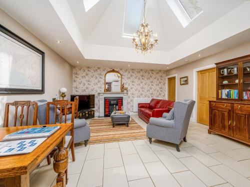 a living room with a red couch and chairs at The Courtyard Apartment - Ukc6965 in Panbride
