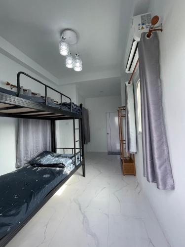 a bedroom with two bunk beds in a room at บ้านพักขอนแก่น888 in Ban Non Muang