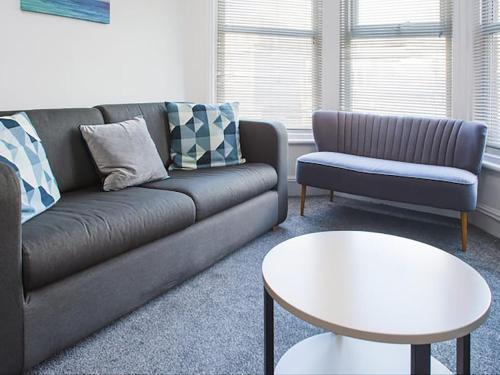 a living room with a couch and a table at Shirehampton Apartment in Shirehampton