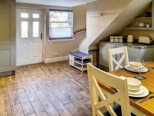 a kitchen and dining room with a table and chairs at Oakbank Cottage - Uk7574 in Pitlochry
