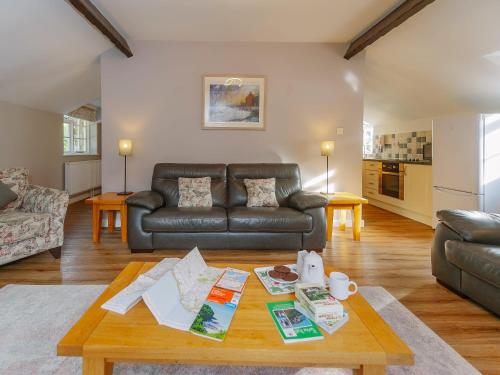 a living room with a leather couch and a table at Number Three - Ukc4965 in Tawstock