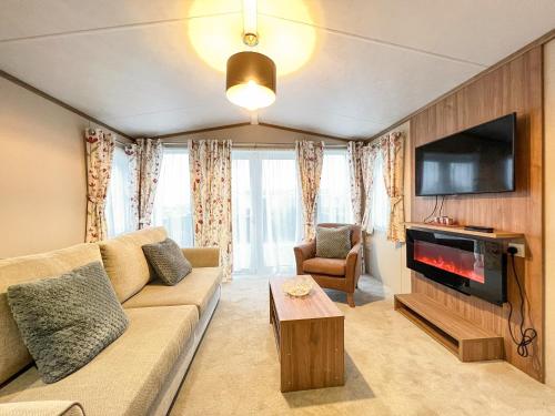 a living room with a couch and a tv at Regent 2 in St. Andrews