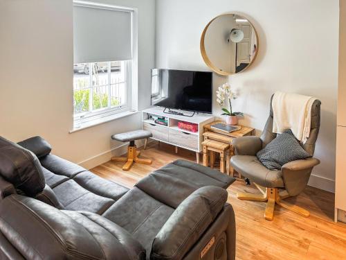 a living room with a couch and a television at Lilypad in Ringwood