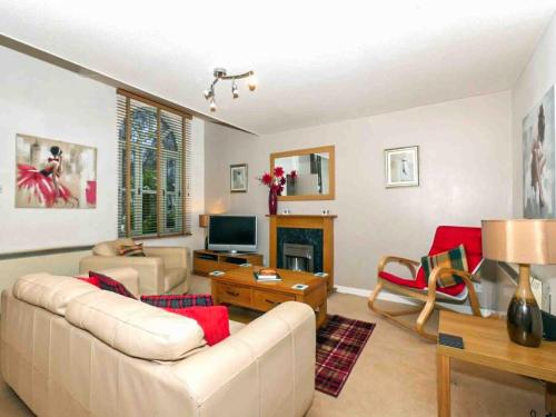 a living room with a couch and a fireplace at Larrach Beag-Ukc5059 in Aviemore
