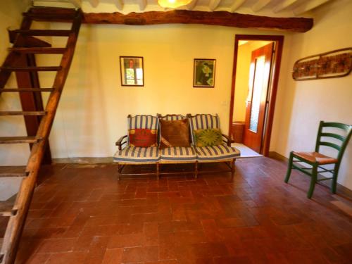 een woonkamer met een bank en een trap bij Dreamy Cottage in Trebbio with Swimming Pool in Pescaglia