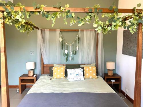 a bedroom with a bed with flowers on it at Penthouse - Sea view, Private roof top pool, Golf in Roches Noires