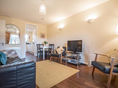 a living room with a couch and a tv at Dalfaber View-Ukc5054 in Aviemore