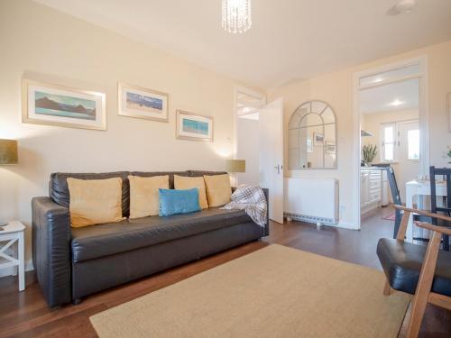 a living room with a couch and a table at Dalfaber View-Ukc5054 in Aviemore