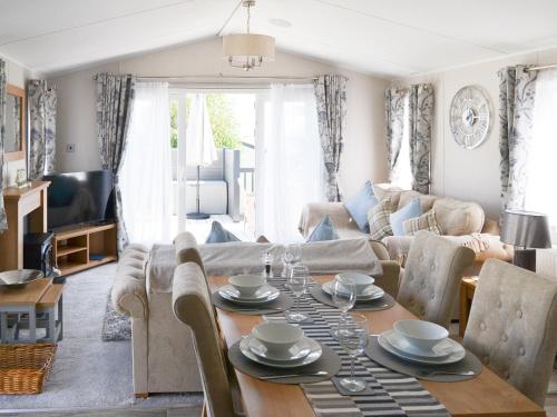 a living room with a table and a couch at Herdwick Lodge - Uk3426 in Newton on the Moor