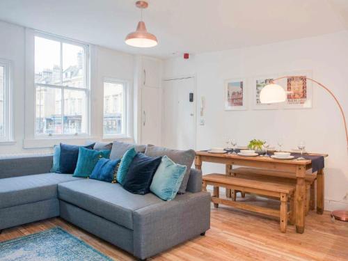 a living room with a couch and a table at Broad Street in Bath
